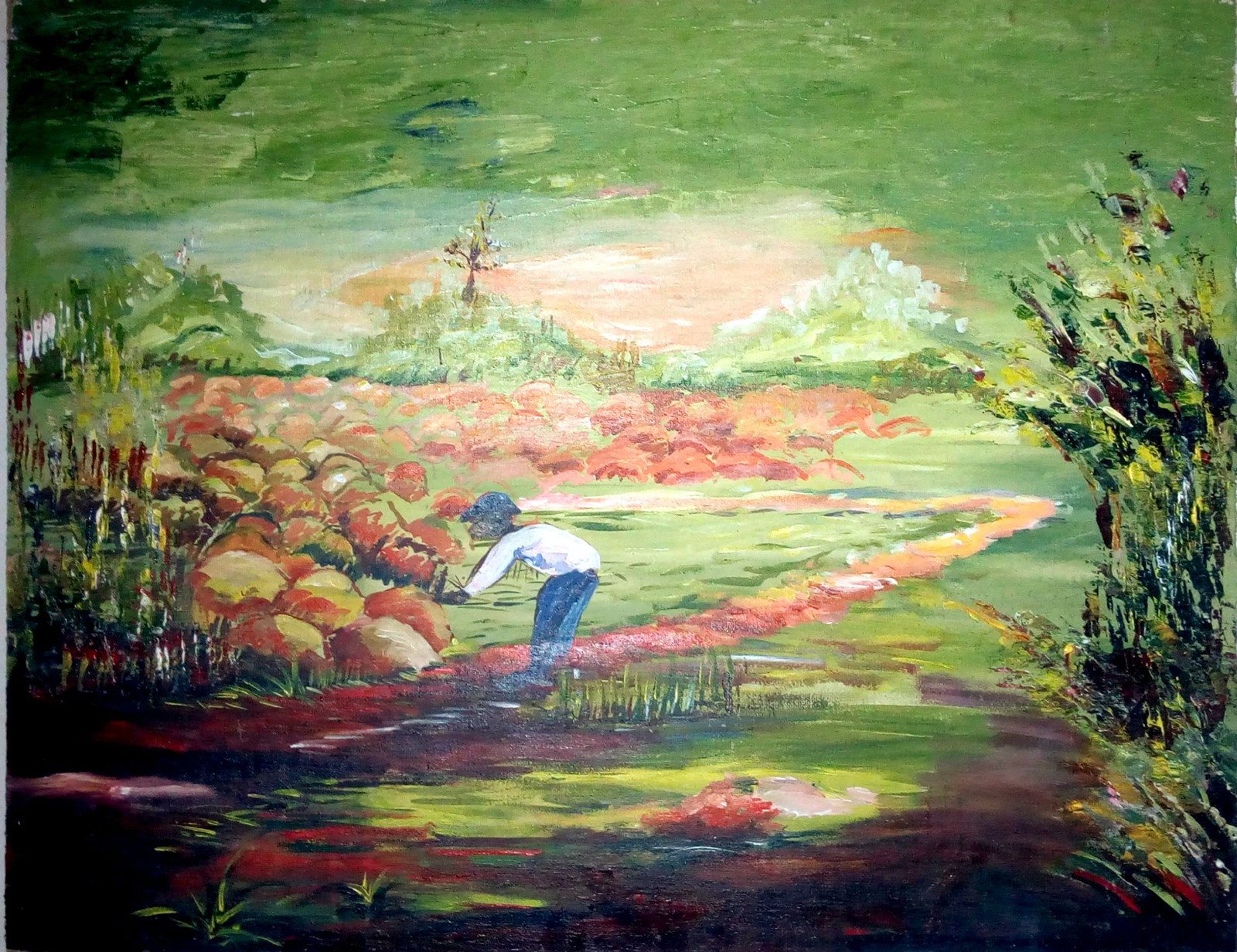 A painting of a green landscape: a figure in a white shirt and blue trousers bends over beside a path, among red and ochre rocks, under a pale glowing sky, with dense foliage at the right edge.